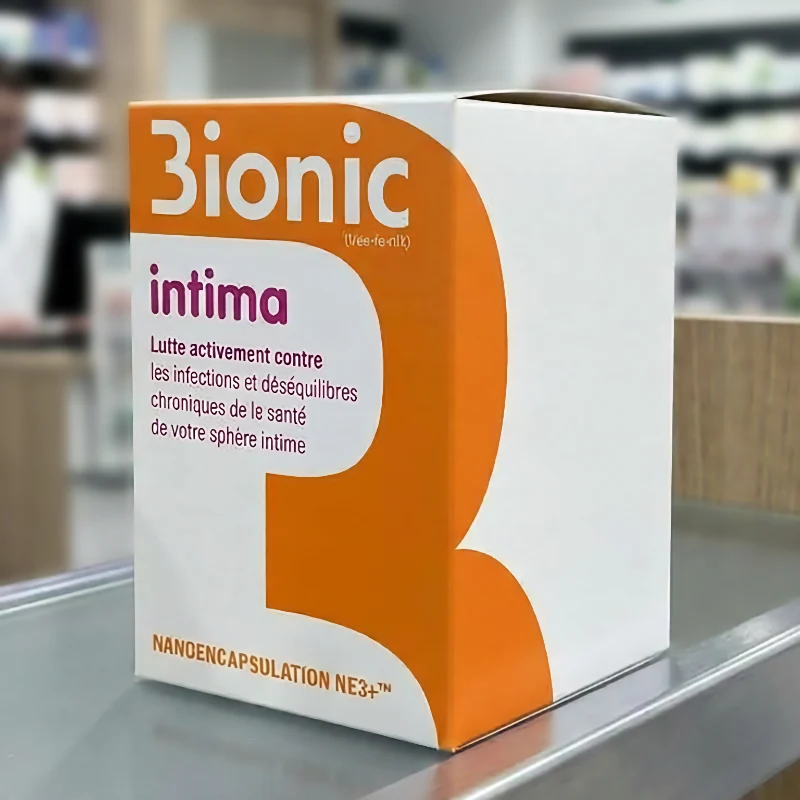 Bo&icirc;te d'emballage orange et blanche 3ionic Intima pos&eacute;e sur un comptoir de pharmacie